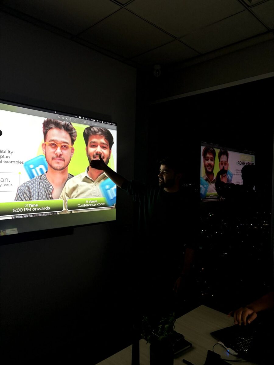 Adshastra LinkedIn workshop poster shown in conference room — internal training on personal brand building